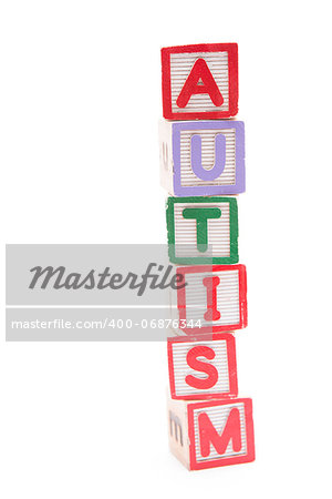 Autism spelled out in stacked letter blocks with copy space on white background