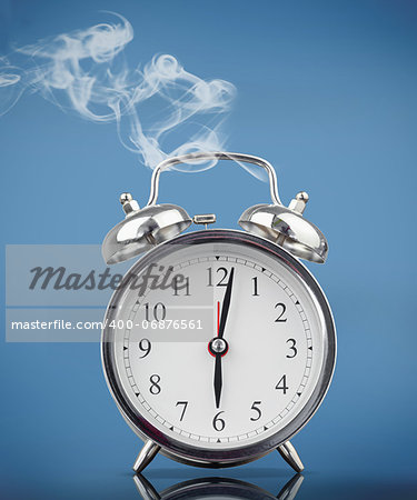 Smoking alarm clock on blue background