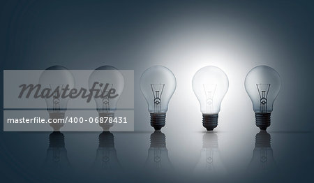 Five light bulbs in row against grey background