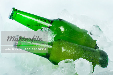 Green Bottle of beer and ice cubes