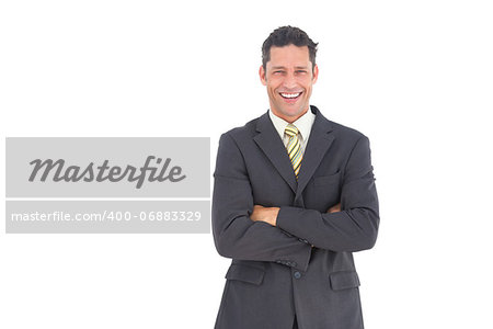 Laughing businessman with crossed arms and white background