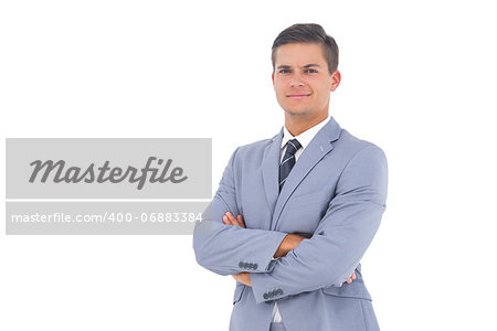 Smart businessman with arms crossed on a white background