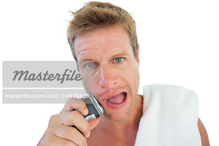 Handsome man shaving his stubble on white background