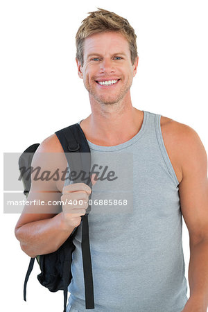 Smiling man in sportswear holding backpack on white background