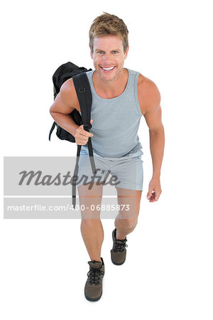 Cheerful man holding backpack on white background