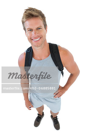 Attractive man in sportswear with hands on hips on white background