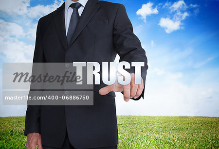 Businessman selecting trust word with landscape on the background