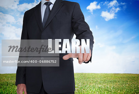 Businessman selecting learn word with landscape on the background