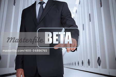 Businessman in a data center selecting label with beta written on it