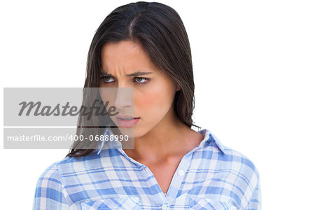 Angry brunette looking at camera on white background