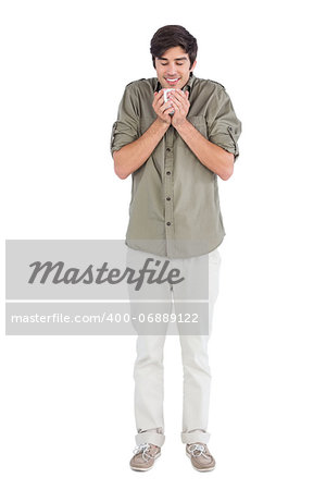 Smiling man enjoying his cup of coffee on a white background