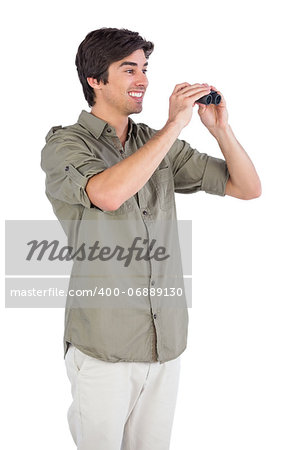 Smiling man using binoculars on a white background