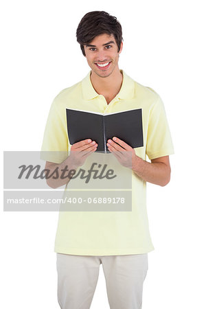 Student holding notebook on a white background