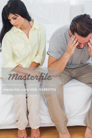 Couple sulking after dispute in bedroom