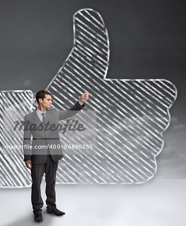 Businessman standing in front of a giant thumb up from the social network