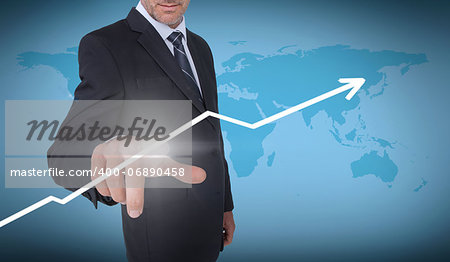 Businessman selecting an arrow pointing up with a world map on the background