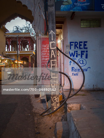 Cafe sign and street view at nightfall in old quarter of Binda, India