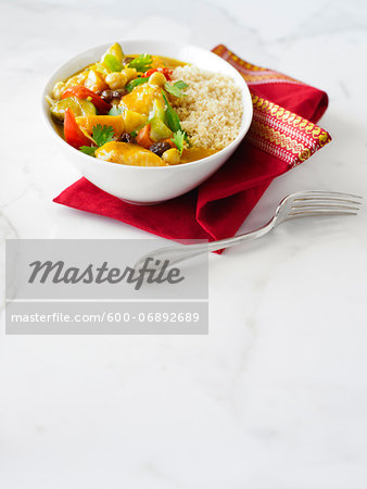 Couscous with Curried Vegetables such as Green Beans, Zucchini, and Red Pepper, this Vegetarian Lunch also includes Cilantro, Chickpeas, and Raisins, Studio Shot