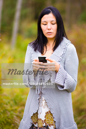 Woman using a smart phone to send a text message