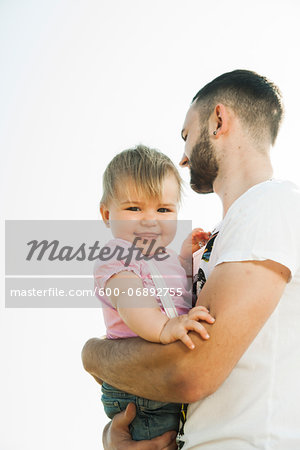 Father holding Baby Daughter Outdoors, Mannheim, Baden-Wurttemberg, Germany