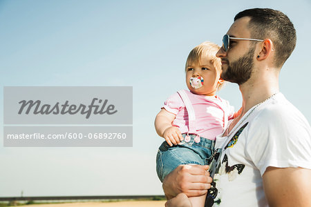 Father Holding Baby Daughter Outdoors, Mannheim, Baden-Wurttemberg, Germany