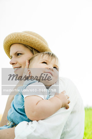 Mother Hugging Baby Daughter Outdoors, Mannheim, Baden-Wurttemberg, Germany