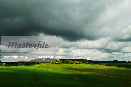 Storm clouds over rolling hills in spring, Vogtland, Saxony, Germany, Europe