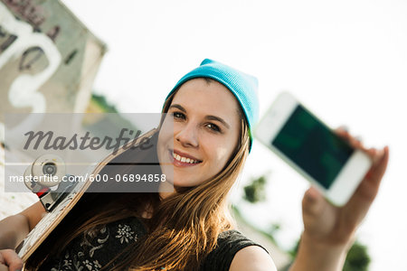 Teenage Girl taking Self Portrait in Skatepark, Feudenheim, Mannheim, Baden-Wurttemberg, Germany