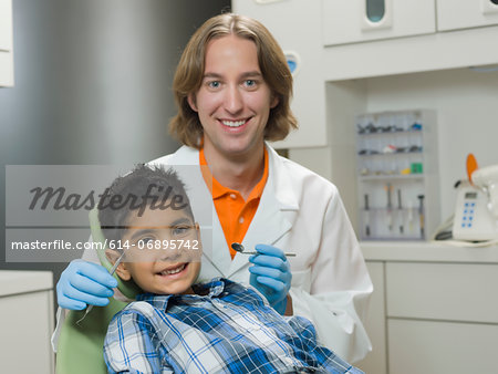 Dentist and young boy smiling, portrait