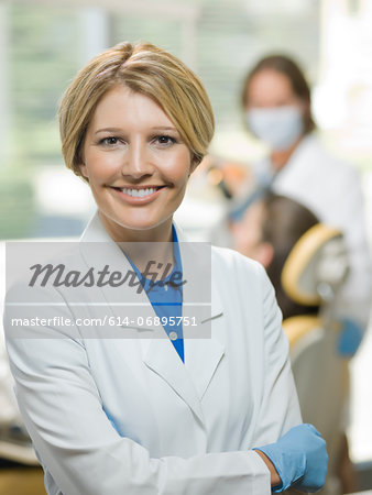 Mid adult dentist smiling, portrait