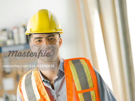 Mid adult construction worker smiling, portrait