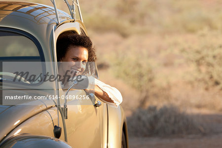 Young woman sitting in car, portrait