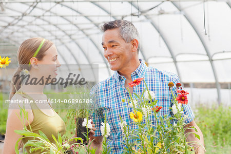 Mature man and mid adult woman shopping in garden centre