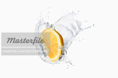 Slice of lemon splashing in liquid
