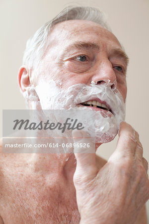Senior man applying shaving cream