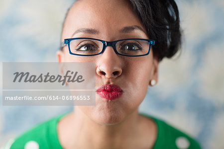 Close up portrait of woman puckering her lips