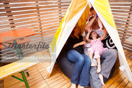 Family playing in tent