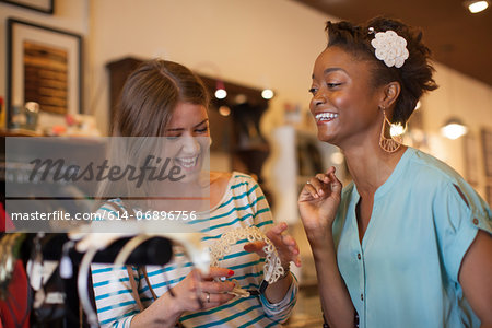 Two young women with headband in vintage shop