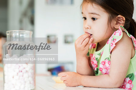 Close up of young girl tasting marshmallows Close up of young girl tasting marshmallows
