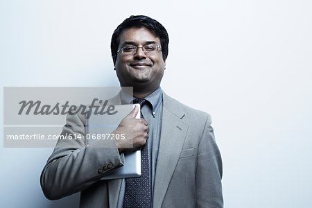 Studio portrait of businessman holding digital tablet