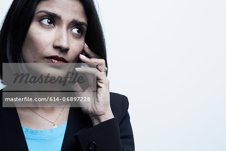 Studio portrait of businesswoman on cellphone