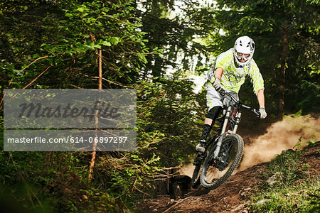 Mountain biker skidding on forest track