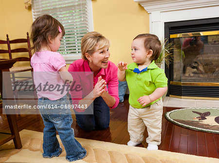 Grandmother and grandchildren playing in dining room Grandmother and grandchildren playing in dining room