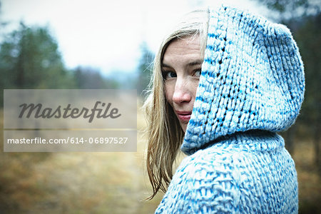 Woman wearing hooded top in forest