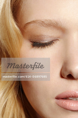 Close-up portrait of blonde woman with eyes closed