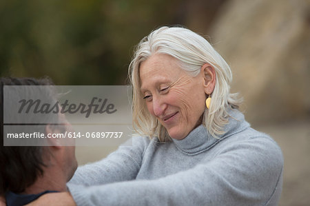 Mature woman smiling with mature man