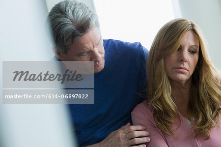 Mature man comforting mature woman