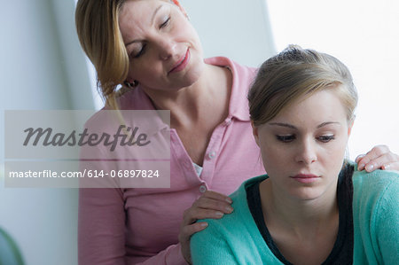 Mother comforting teenage daughter