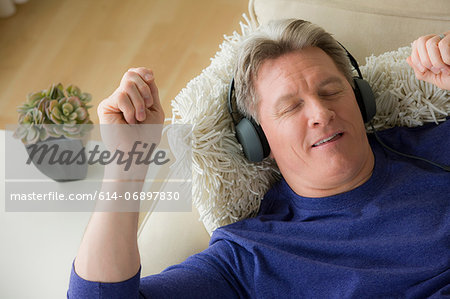 Mature man wearing headphones, smiling