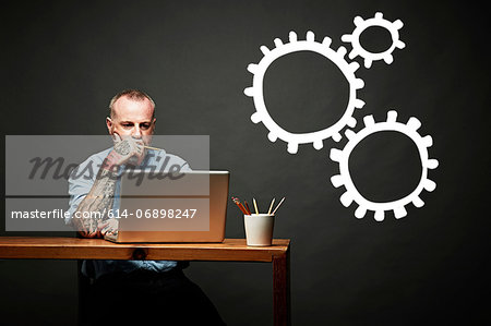 Conceptual image of man as cog in the wheel